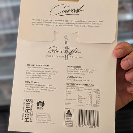 Product packaging with text and branding held by a person
