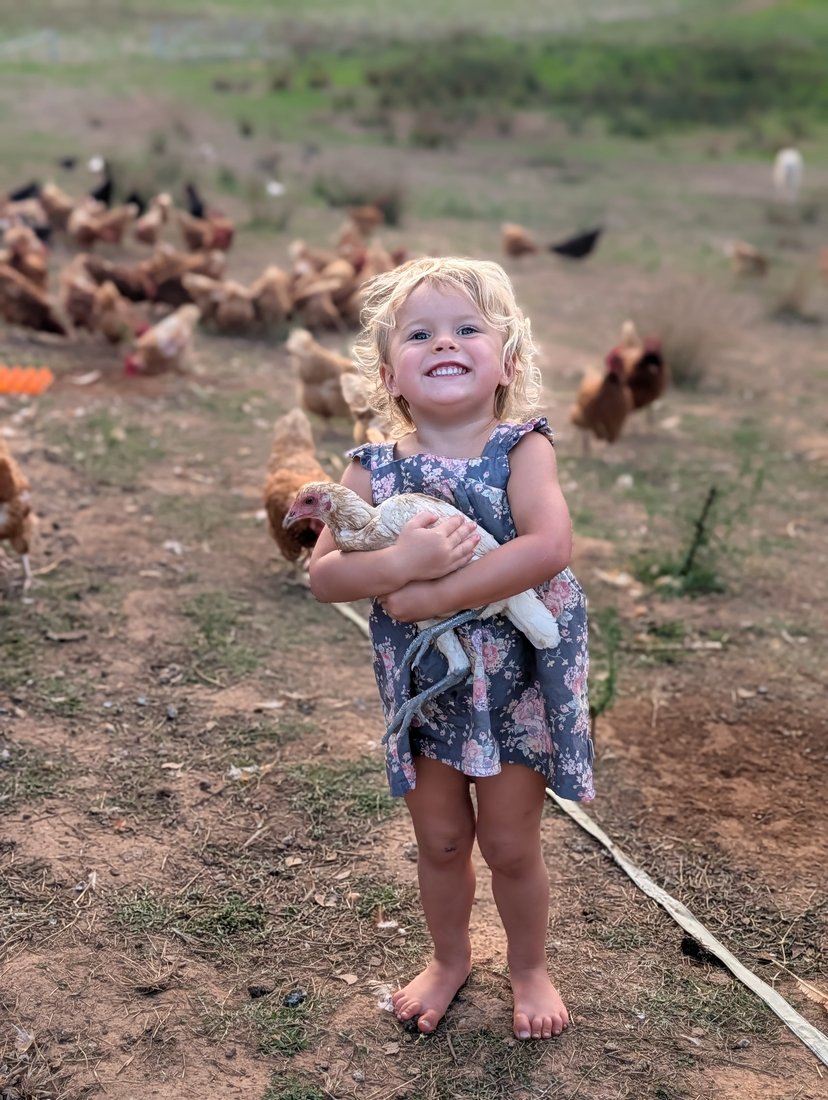 Girl with the Ottofowl flock on pasture