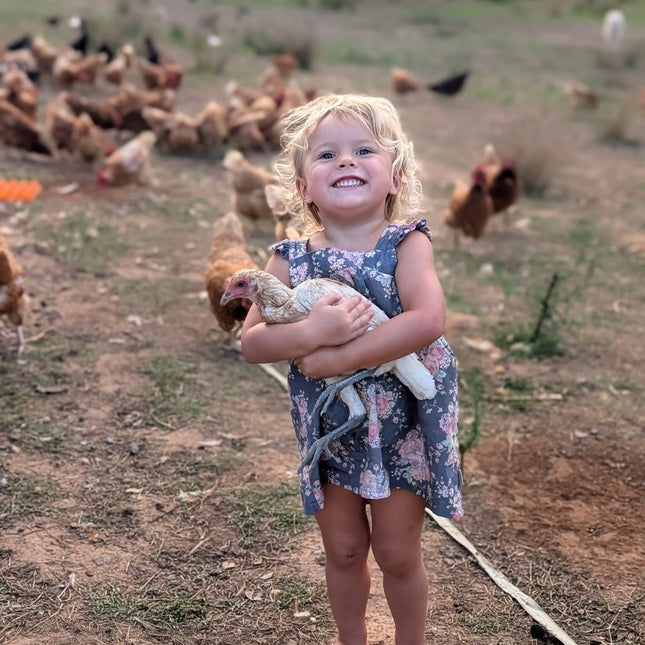 Girl with the Ottofowl flock on pasture
